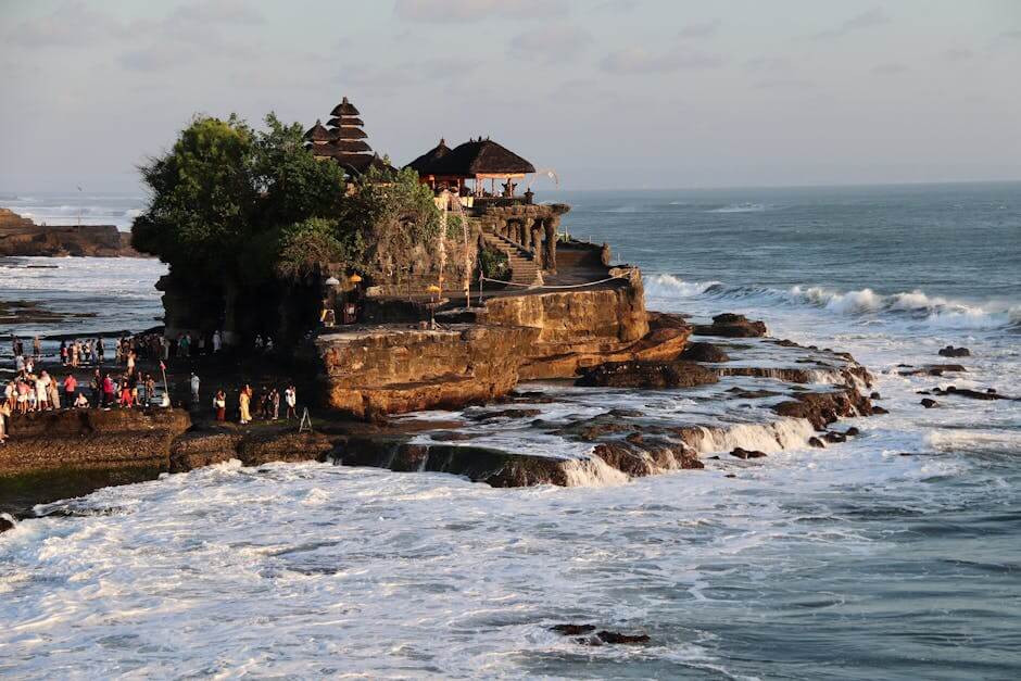 pexels-photo-18144499-18144499 Breathtaking view of Tanah Lot Temple on the rocky coast of Bali, Indonesia, during sunset.